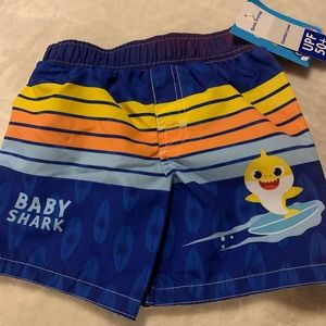 Baby Shark swim trunks size 12 months. Drawstring waist and mesh inner lining.